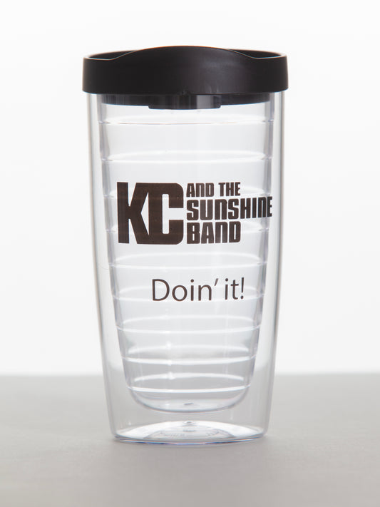 A clear plastic tumbler with a black lid, featuring the text 'KC and the Sunshine Band' and 'Doin' it!' printed in black.