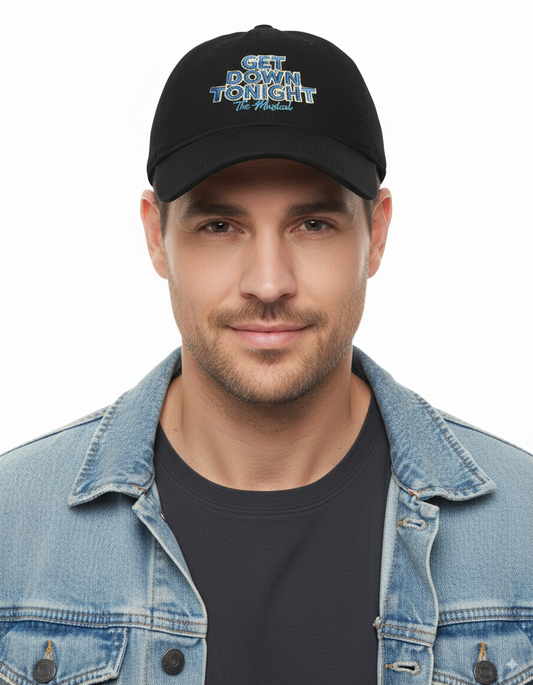 Man wearing a black cap with text and a denim jacket on a white background