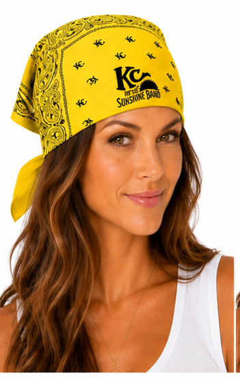 A woman wearing a yellow bandana headwrap with a black paisley pattern and 'KC and the Sunshine Band' logo, shown against a plain white background.