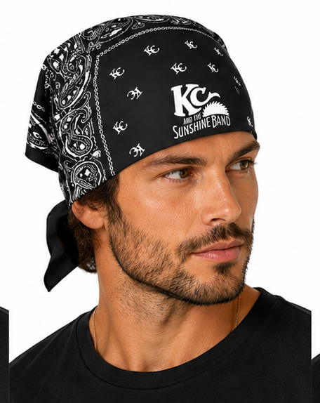 A man wearing a black bandana with a white paisley pattern and the 'KC and the  Sunshine Band' logo, shown in a close-up profile shot against a white background.