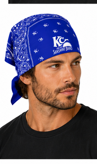 A man wearing a royal blue bandana with a white paisley pattern and the KC  and the Sunshine Band' logo, paired with a black t-shirt against a white background.
