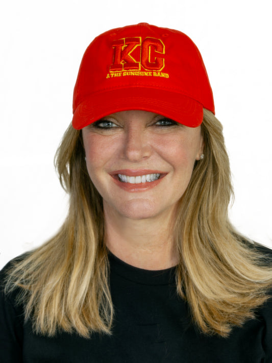 A person wearing a black 'KC' logo cap with a red embroidered 3D design.