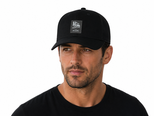 Man wearing a black cap with a logo on a white background